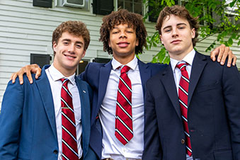 A student puts his arms around his classmates. Links to Closely Held Business Stock