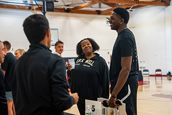  A woman listens to a student, amused. Links to Beneficiary Designations