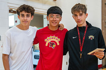 Students standing together in a hallway. Links to Gifts of Appreciated Securities