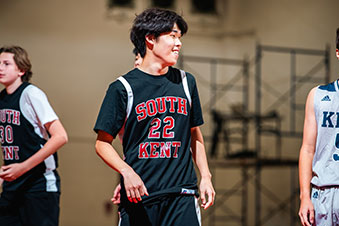 A student smiling, showing good sportsmanship at a basketball game. Links to Tangible Personal Property