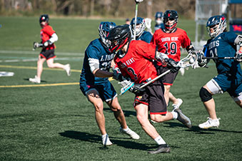Students playing lacrosse. Links to Gifts of Cash, Checks, and Credit Cards